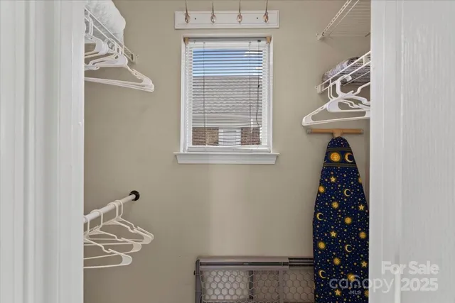 a room with a window and a white door