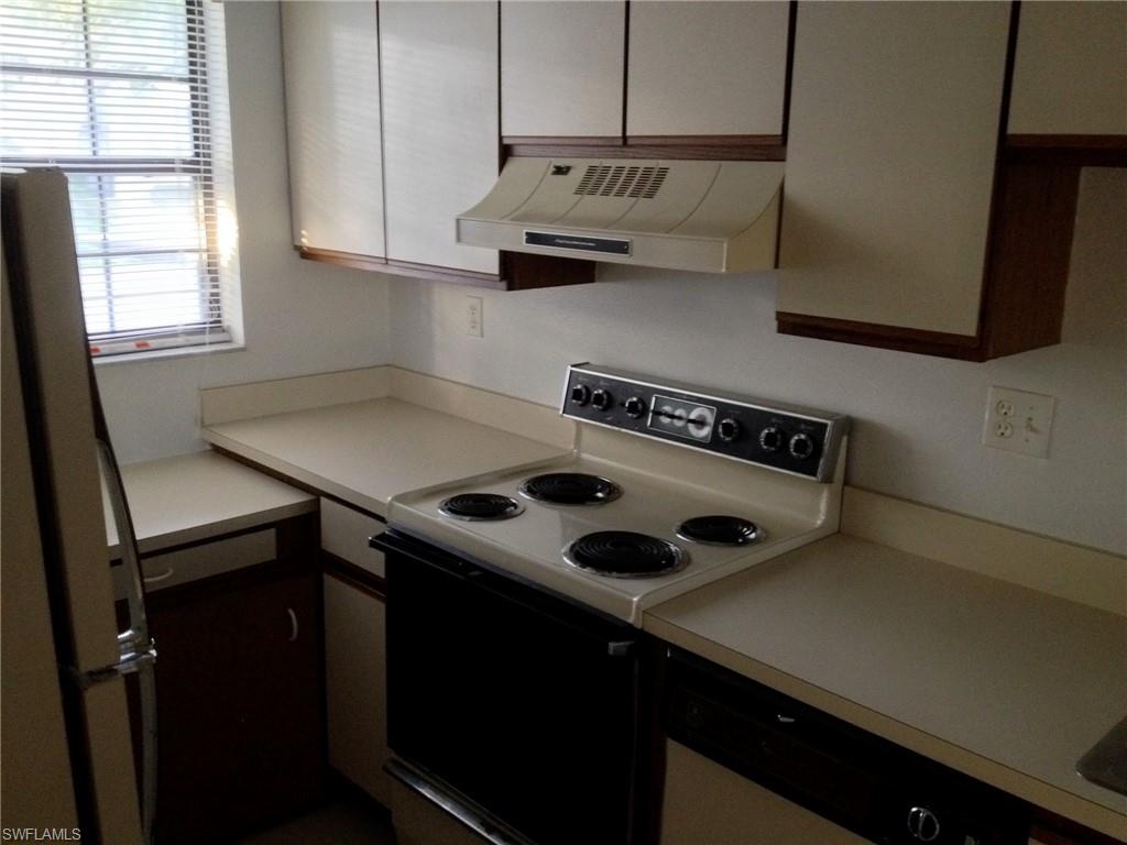 5339 Treetops Drive, Unit T105 Naples, FL 34113 - Photo 14 of 16 a kitchen with a stove and a refrigerator