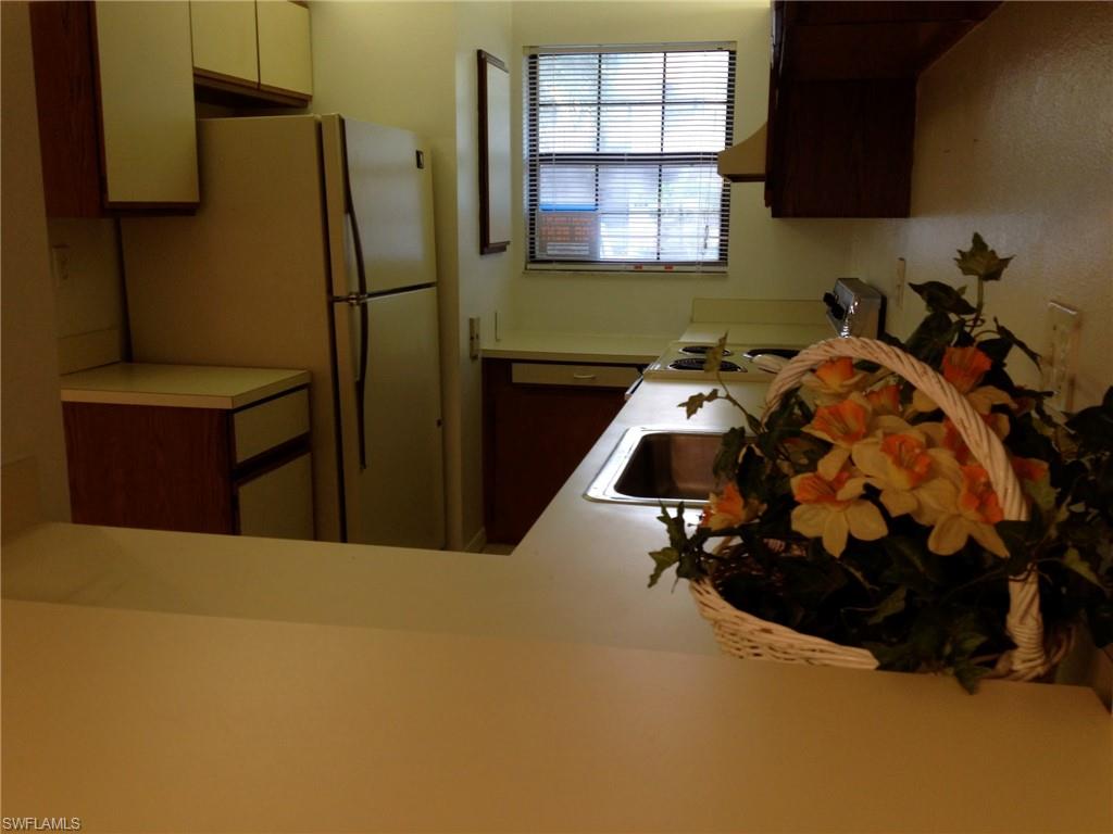 5339 Treetops Drive, Unit T105 Naples, FL 34113 - Photo 3 of 16 a bedroom with bed and a window