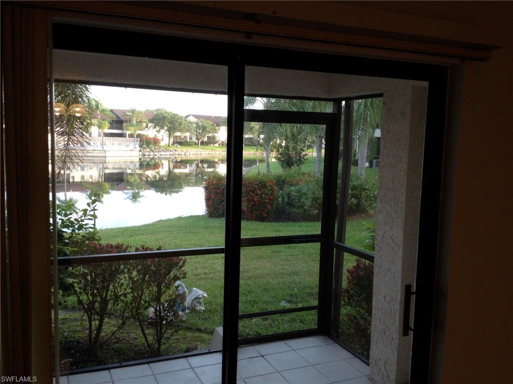 5339 Treetops Drive, Unit T105 Naples, FL 34113 - Photo 5 of 16 a view of a glass door and an outdoor space