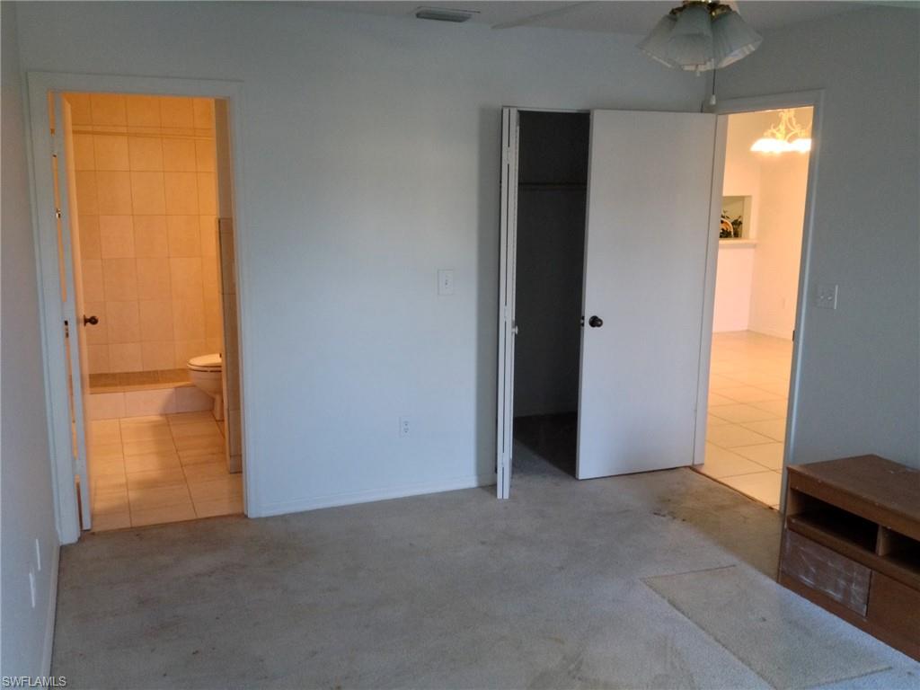 5339 Treetops Drive, Unit T105 Naples, FL 34113 - Photo 8 of 16 an empty room with windows