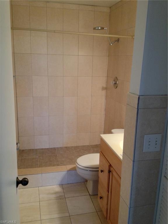 5339 Treetops Drive, Unit T105 Naples, FL 34113 - Photo 9 of 16 a bathroom with a sink a toilet and shower