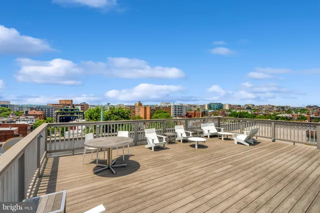a view of a terrace with wooden benches