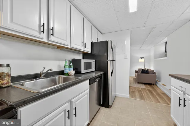 a kitchen with stainless steel appliances a sink a stove and a refrigerator