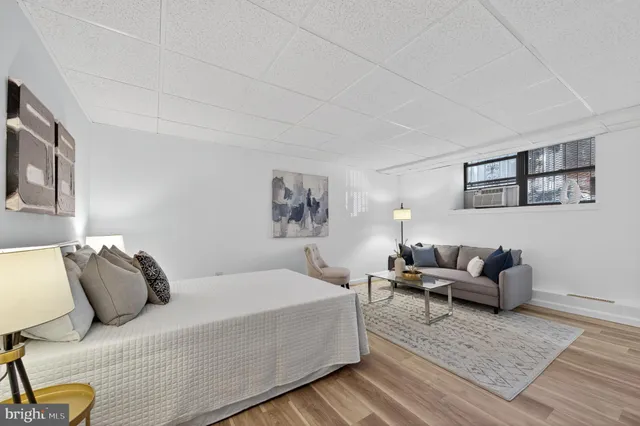 a bedroom with furniture and painting on the wall