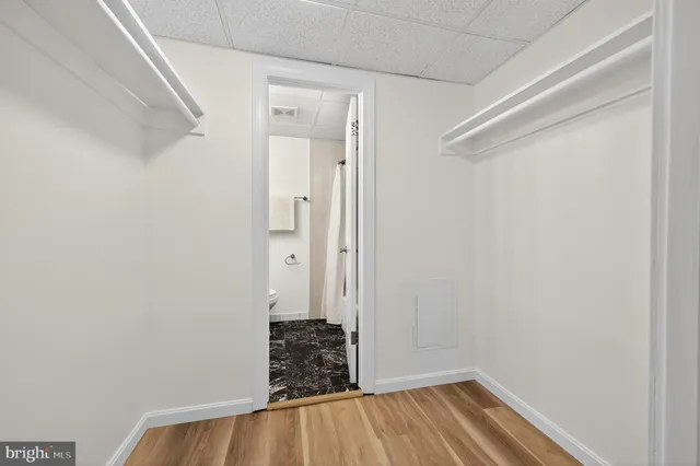a view of a room with wooden floor and a window