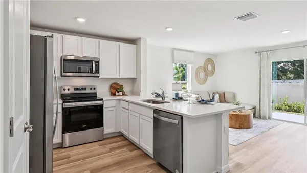 a kitchen with a sink stove and cabinets