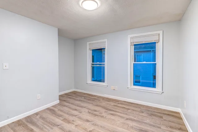 a view of room with window and hardwood floor