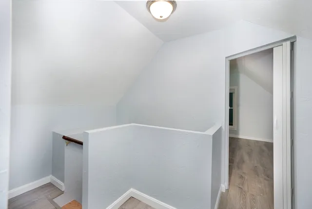 a view of a room with wooden floor