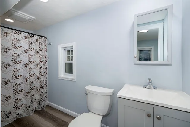 a bathroom with a shower and a toilet