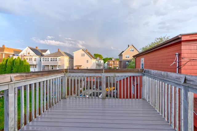 a view of a balcony with wooden floor