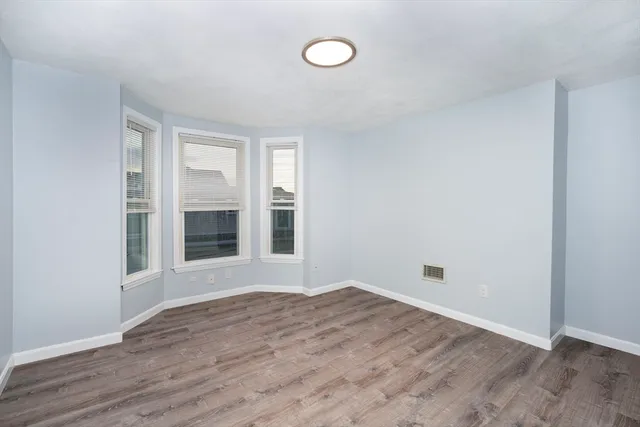 a view of a room with wooden floor