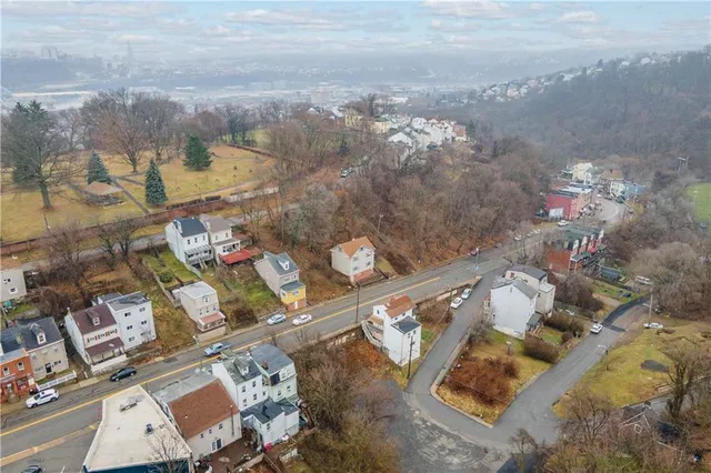 an aerial view of a house with a yard