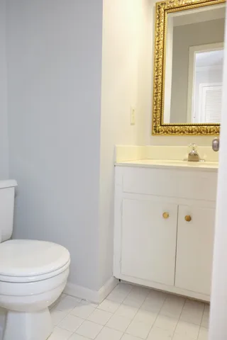 a bathroom with a toilet a sink and mirror