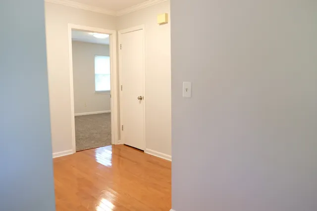 a view of a hallway with wooden floor