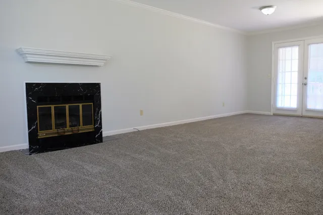 a view of empty room with a fireplace