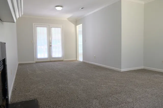 an empty room with windows and closet