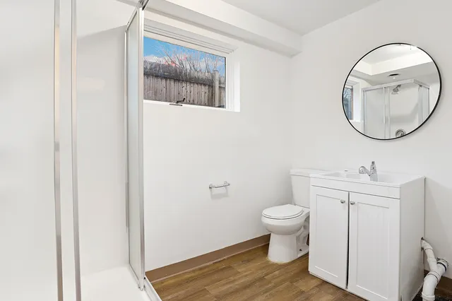 a bathroom with a toilet and a mirror