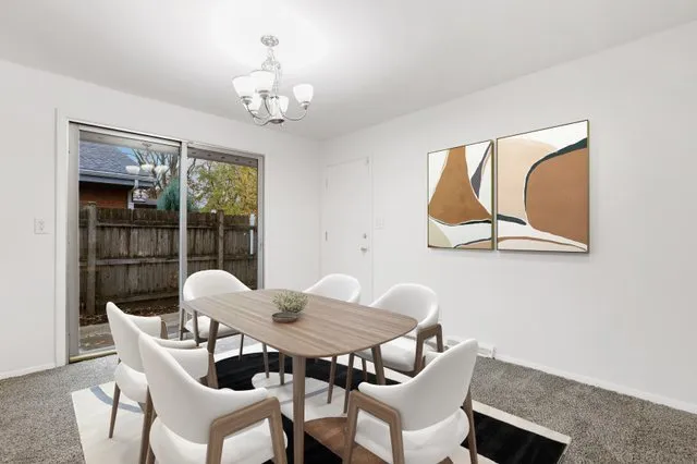 a view of a dining room with furniture wooden floor and a chandelier