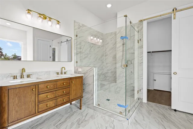 a bathroom with a shower sink and mirror