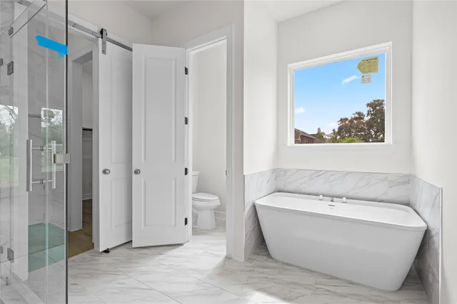 a bathroom with a bathtub and a shower