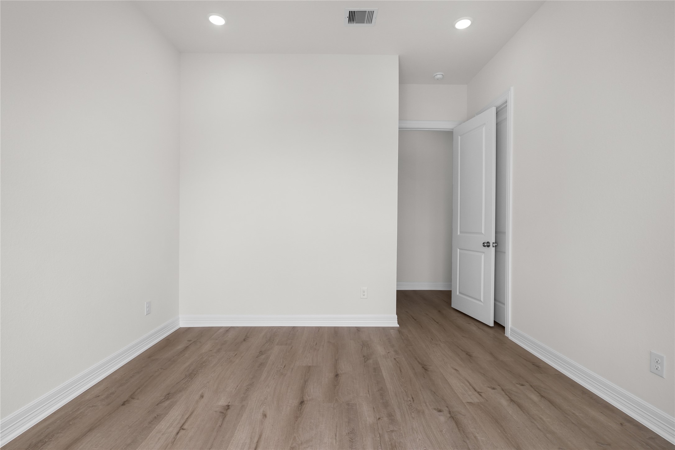 1720 Flintlock Court Angleton, TX 77515 - Photo 25 of 32 a view of an empty room with wooden floor