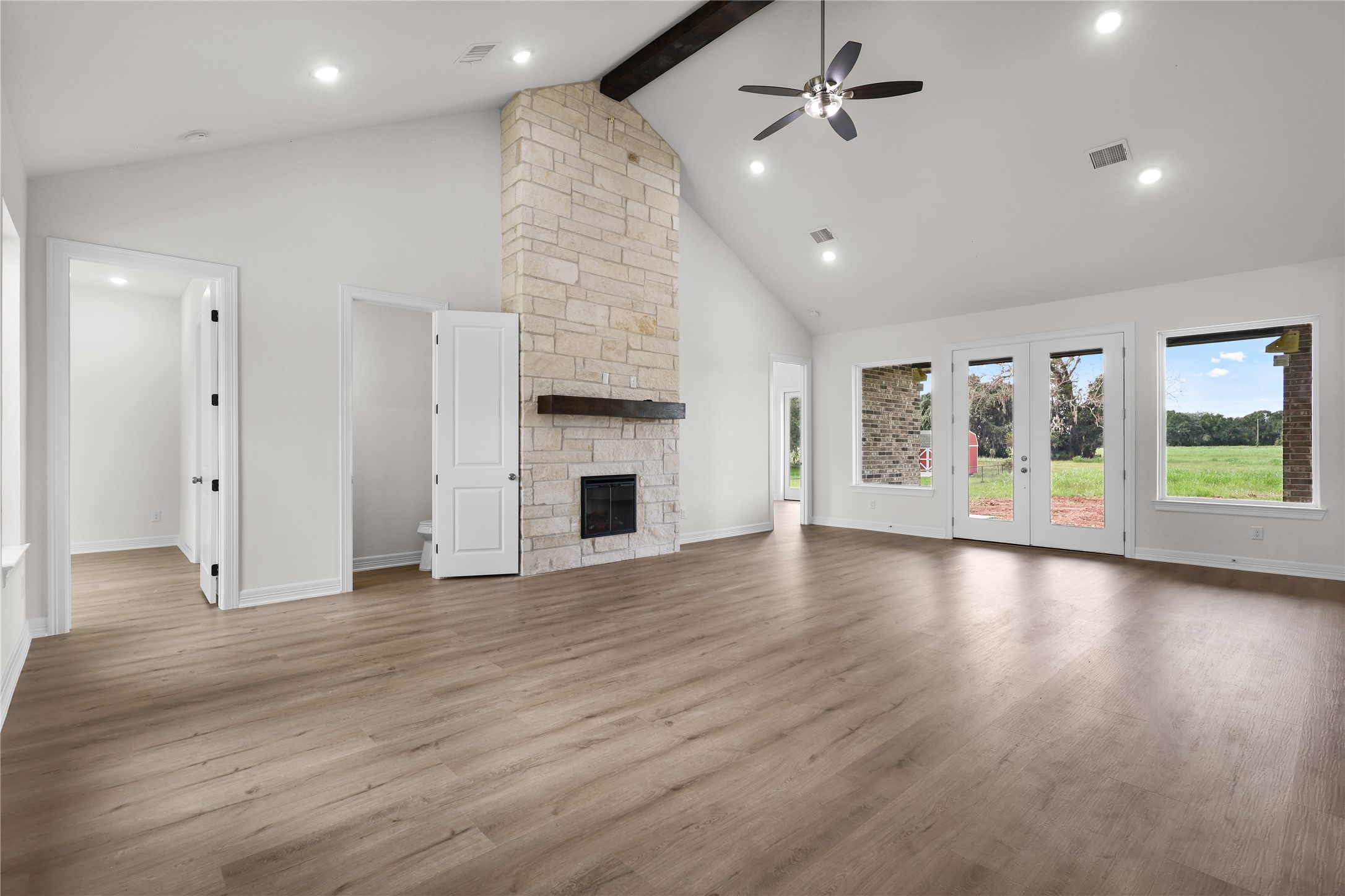 1720 Flintlock Court Angleton, TX 77515 - Photo 5 of 32 an empty room with wooden floor fireplace and windows