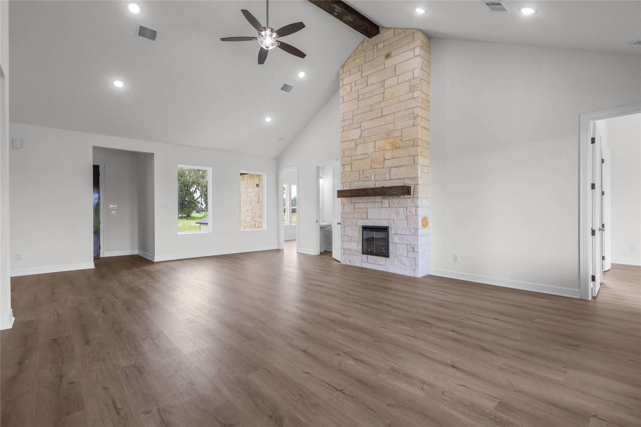 1720 Flintlock Court Angleton, TX 77515 - Photo 8 of 32 an empty room with wooden floor fireplace and windows