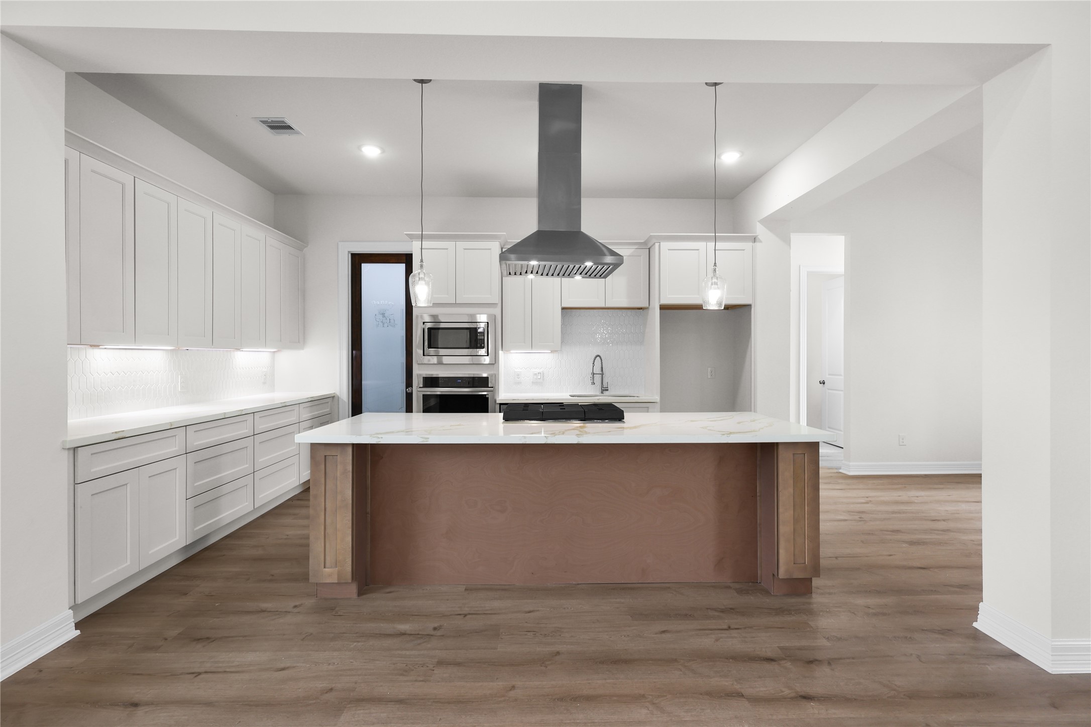 1720 Flintlock Court Angleton, TX 77515 - Photo 9 of 32 a large kitchen with stainless steel appliances a large counter top a stove and a refrigerator