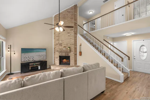 a living room with fireplace and a chandelier