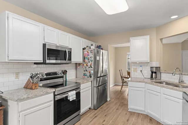 a kitchen with a sink stove and microwave