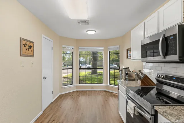 a kitchen with stainless steel appliances a stove sink microwave and cabinets