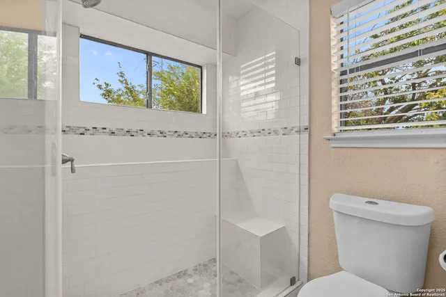 a bathroom with a toilet and a shower