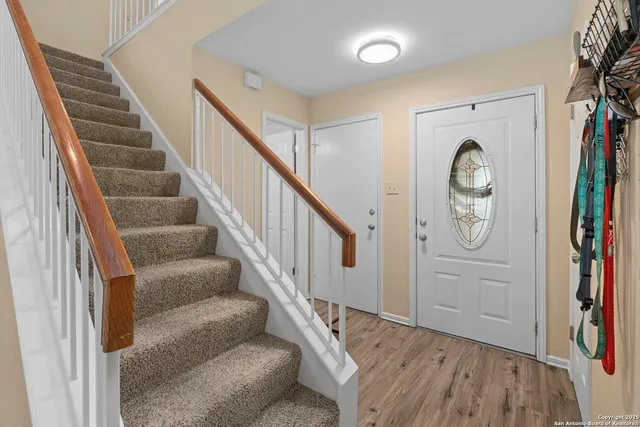 a view of entryway with wooden floor and stairs