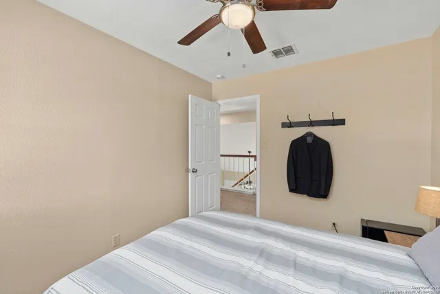 a bedroom with a bed and a painting on the wall