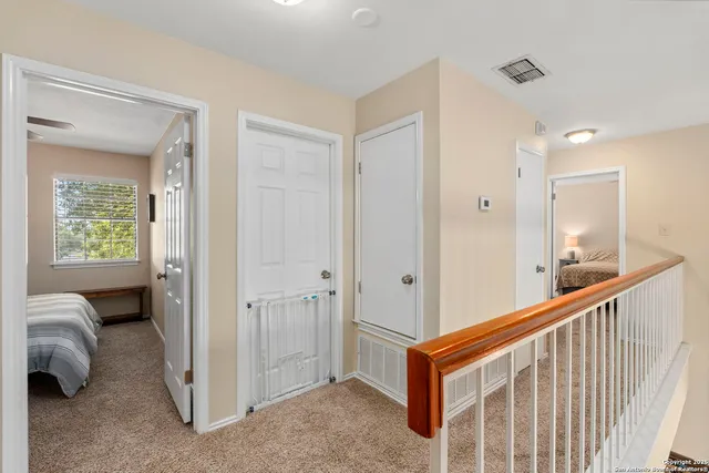 a view of a hallway and a livingroom with furniture