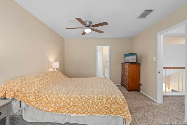 a bedroom with a bed and cabinets
