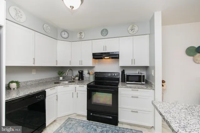 a kitchen with cabinets appliances and a counter space
