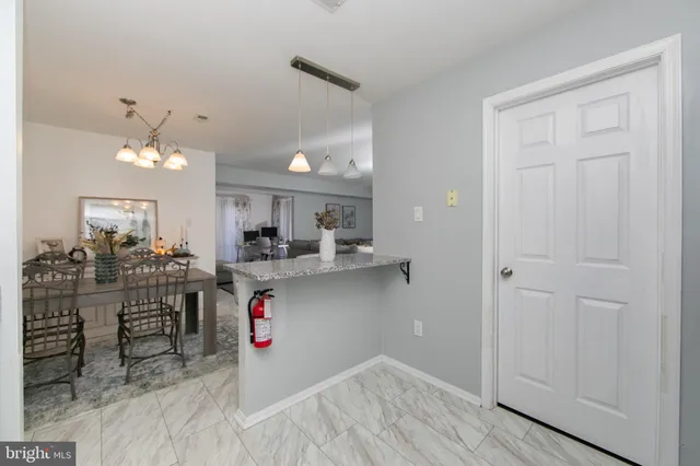 a kitchen view with stainless steel appliances granite countertop a sink and cabinets