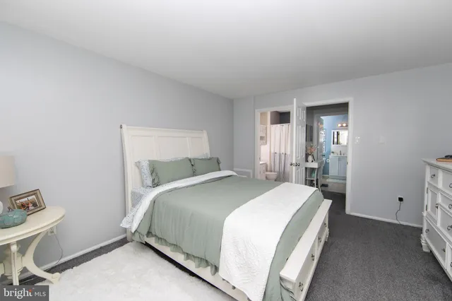 a bedroom with a bed and a table in it