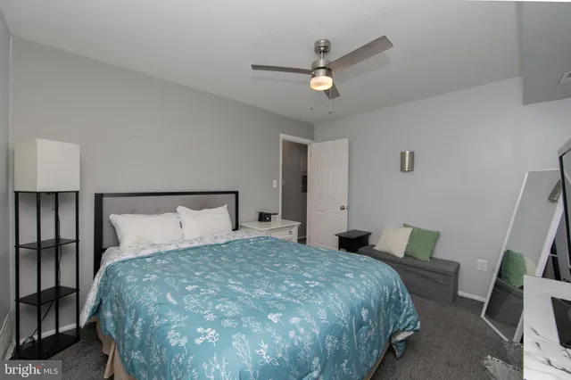 a bedroom with a bed and a large mirror