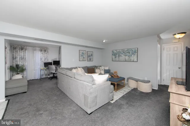 a living room with furniture and white walls