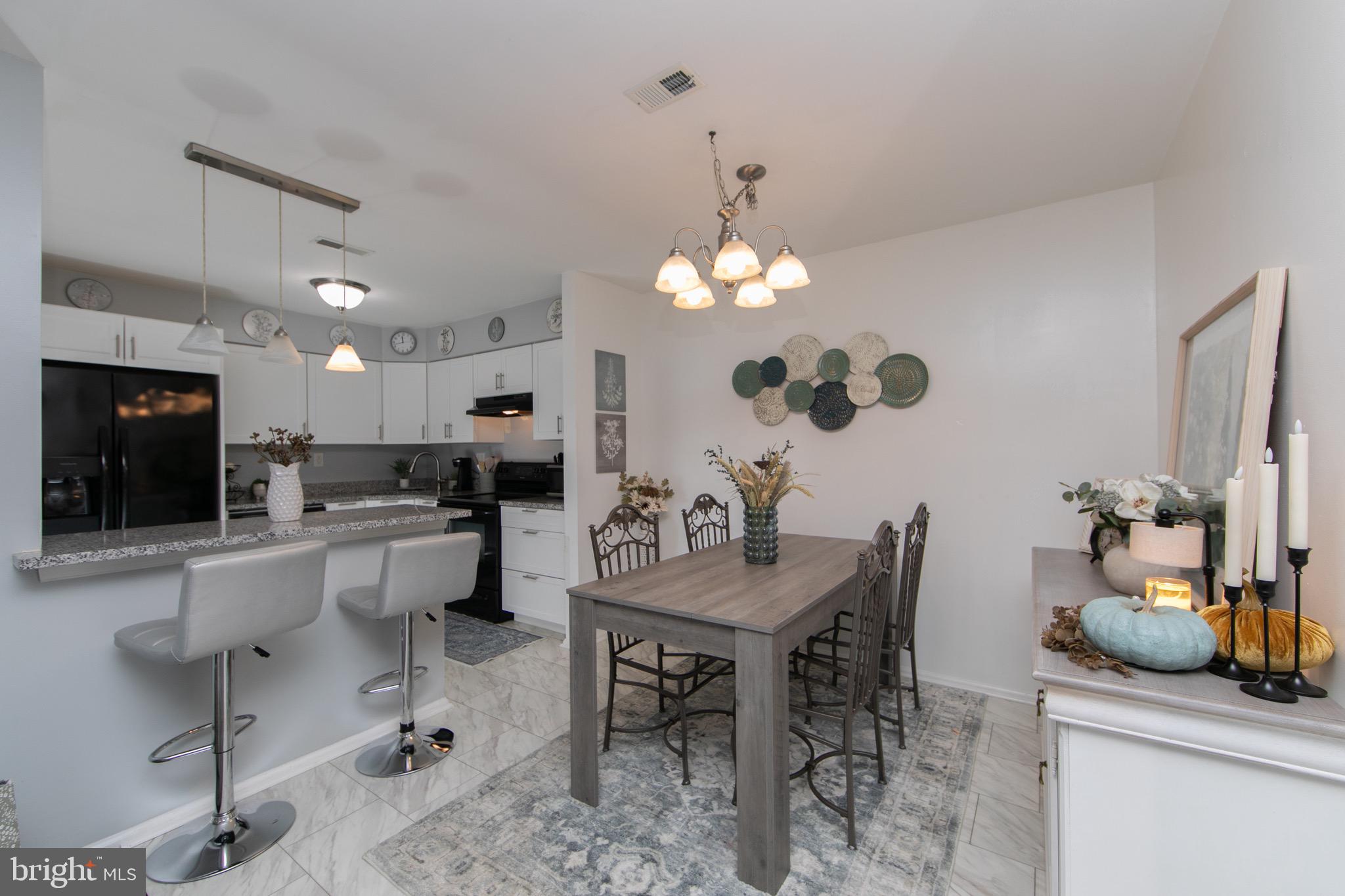 123 Birchfield Court Mount Laurel, NJ 08054 - Photo 6 of 32 a living room with furniture a flat screen tv and kitchen view