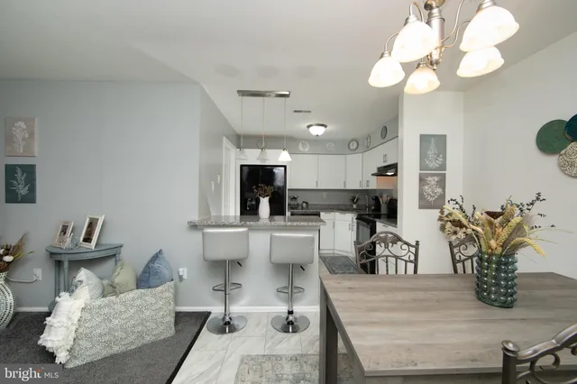 a living room with furniture and view of kitchen