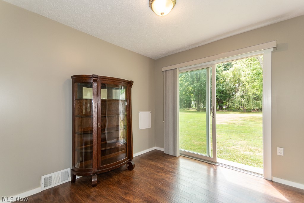 38488 Bell Road Willoughby, OH 44094 - Photo 5 of 22 Unfurnished room with hardwood / wood-style flooring and a textured ceiling