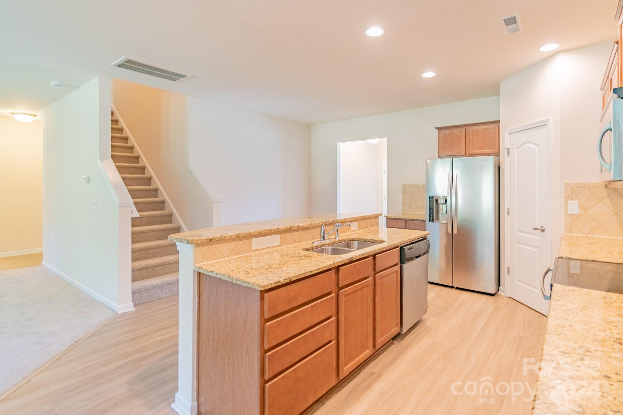 8715 Balsam Bay Road Charlotte, NC 28227 - Photo 11 of 29 a kitchen with a sink and refrigerator