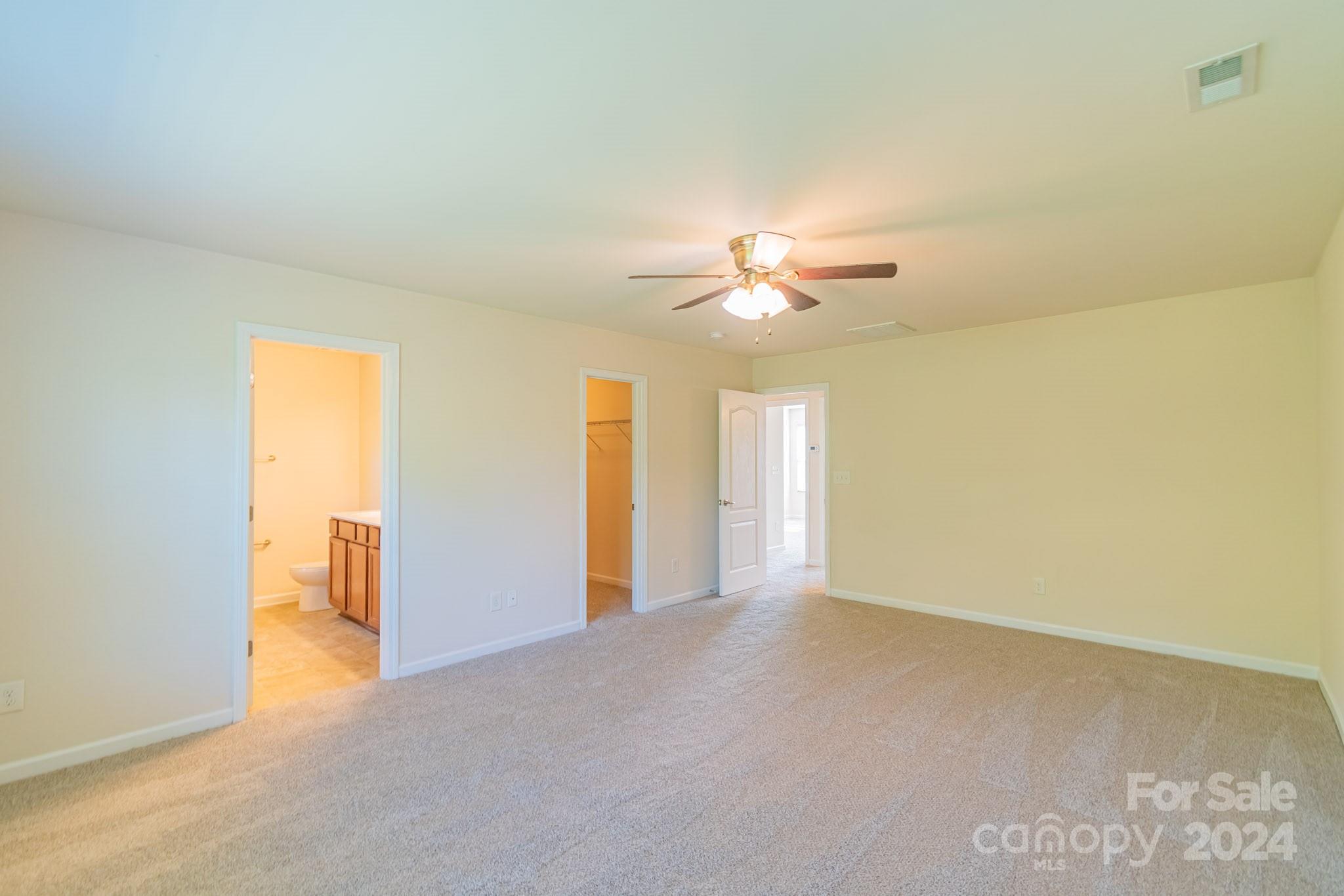 8715 Balsam Bay Road Charlotte, NC 28227 - Photo 13 of 29 a view of an empty room with a chandelier fan