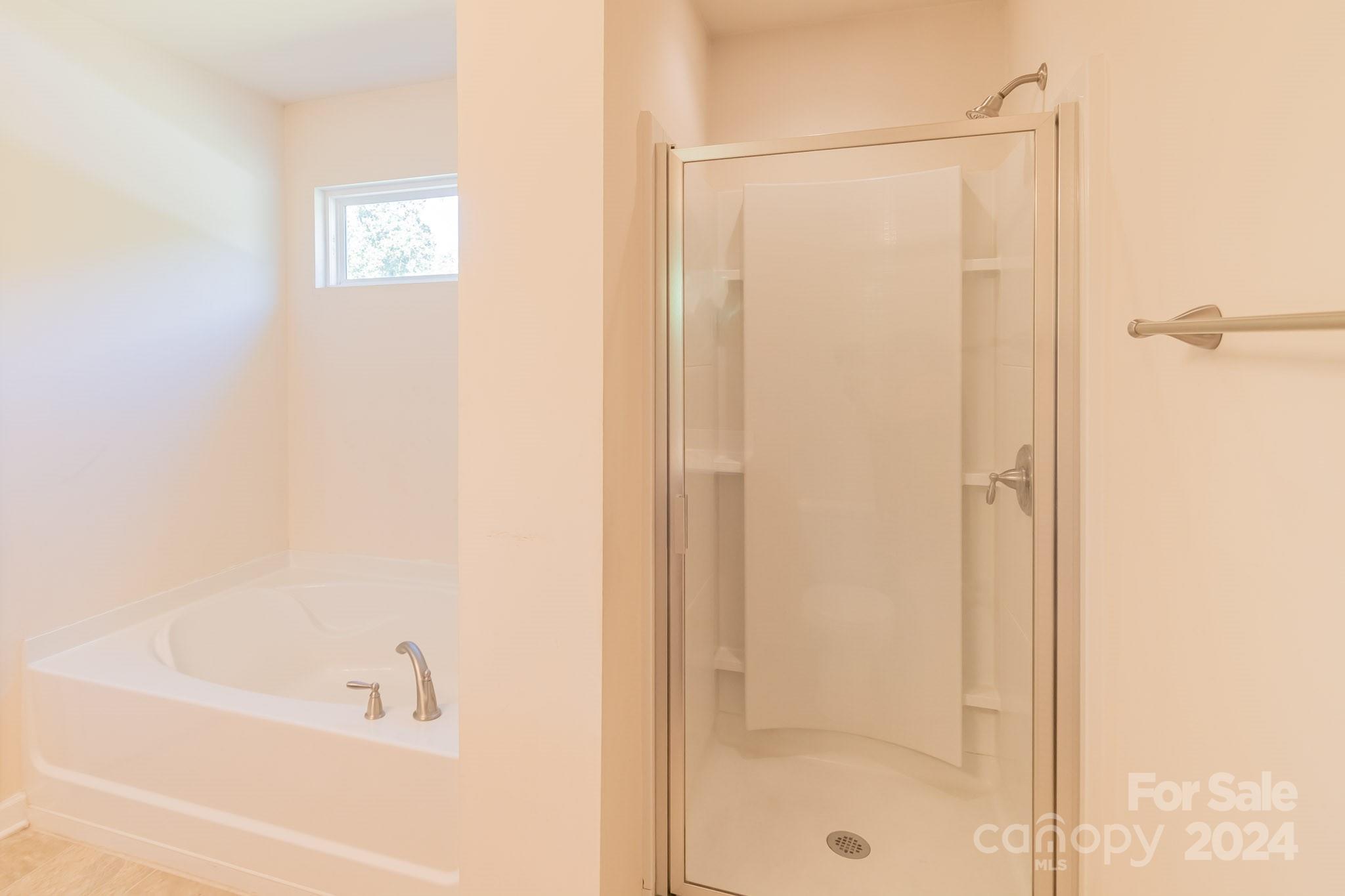 8715 Balsam Bay Road Charlotte, NC 28227 - Photo 15 of 29 a bathroom with a bathtub and a shower