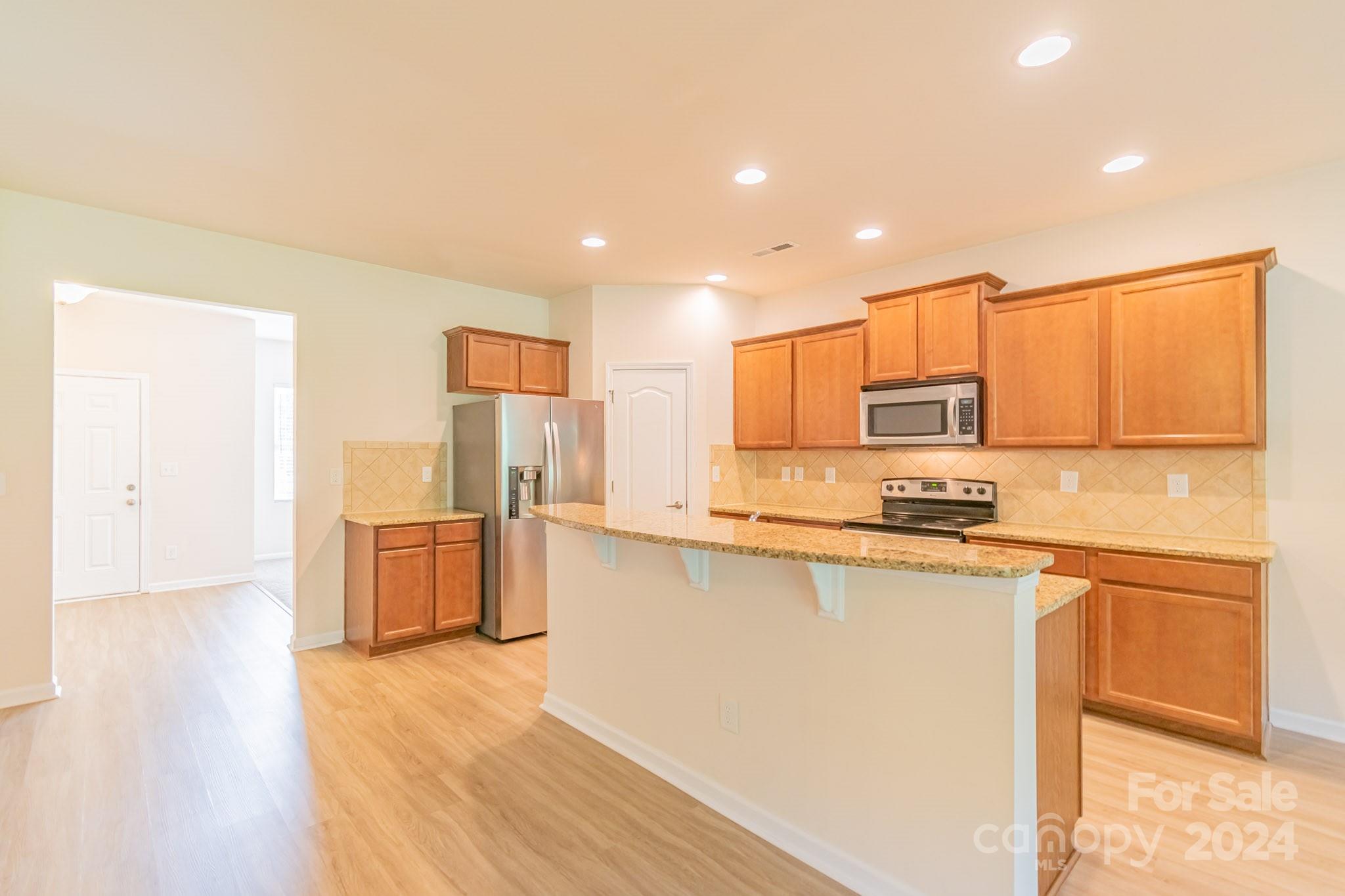 8715 Balsam Bay Road Charlotte, NC 28227 - Photo 5 of 29 a kitchen with stainless steel appliances a refrigerator sink and microwave