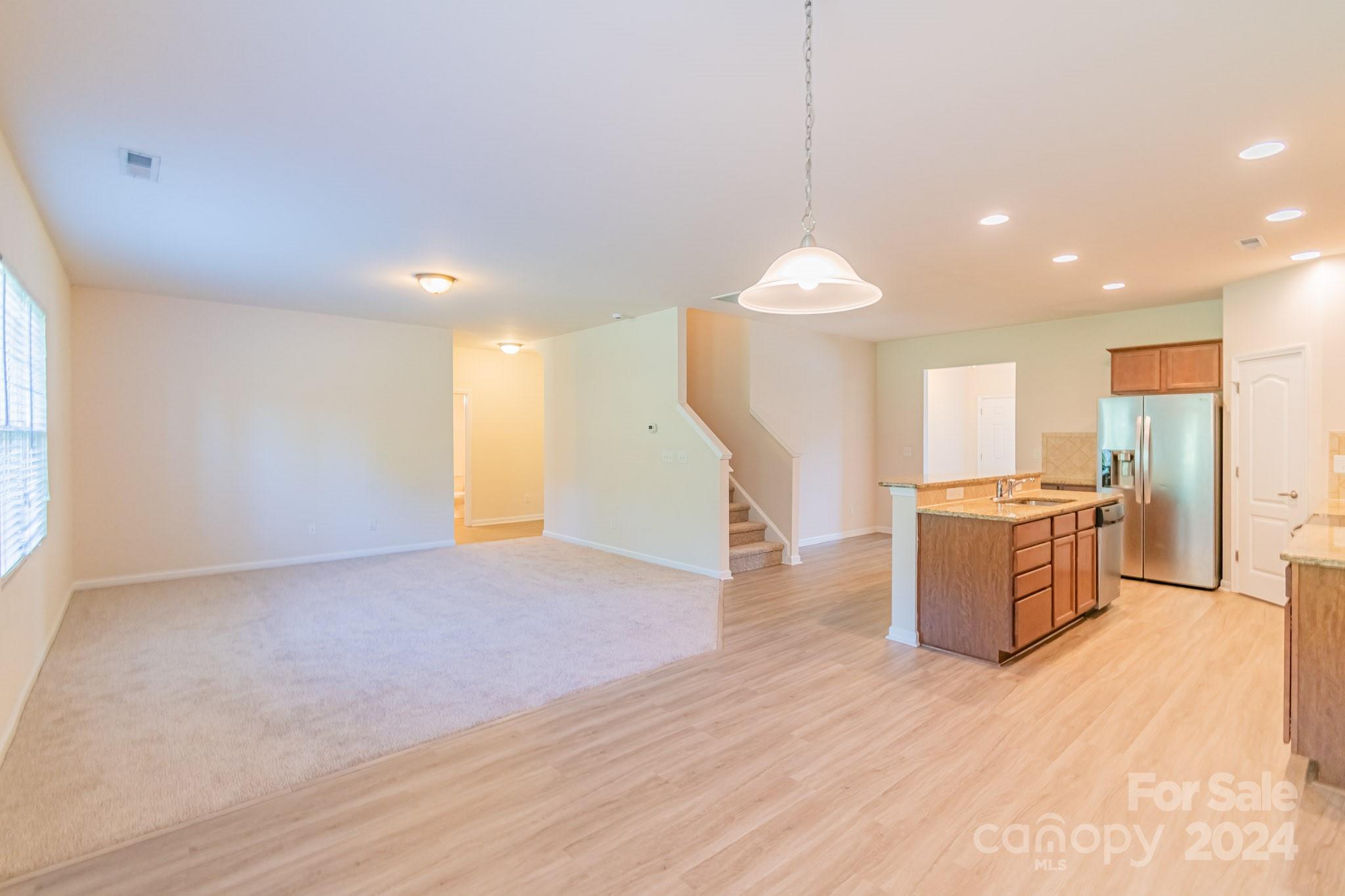 8715 Balsam Bay Road Charlotte, NC 28227 - Photo 8 of 29 a view of a kitchen with a sink and a living room view